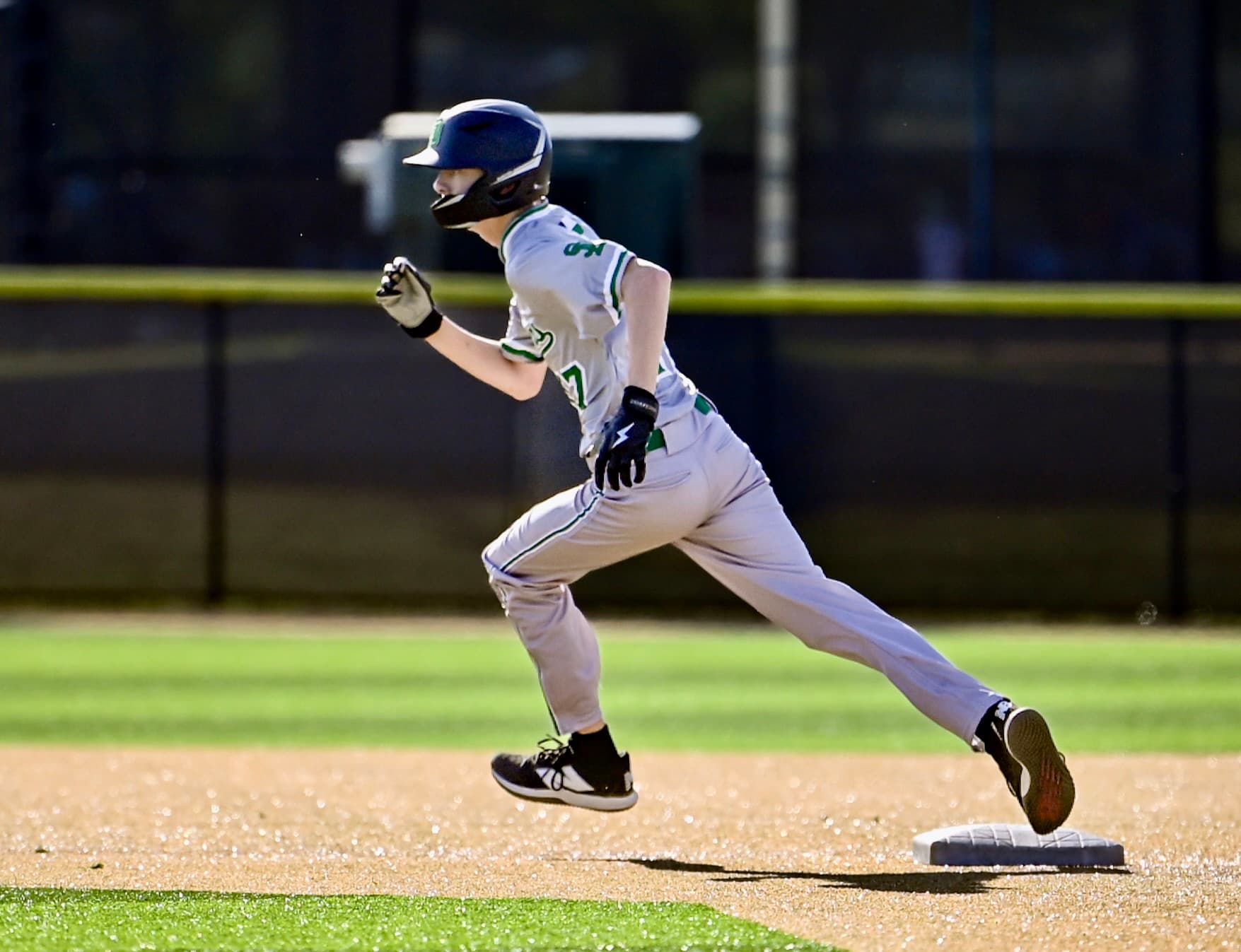 Youth baseball player rounding the bases